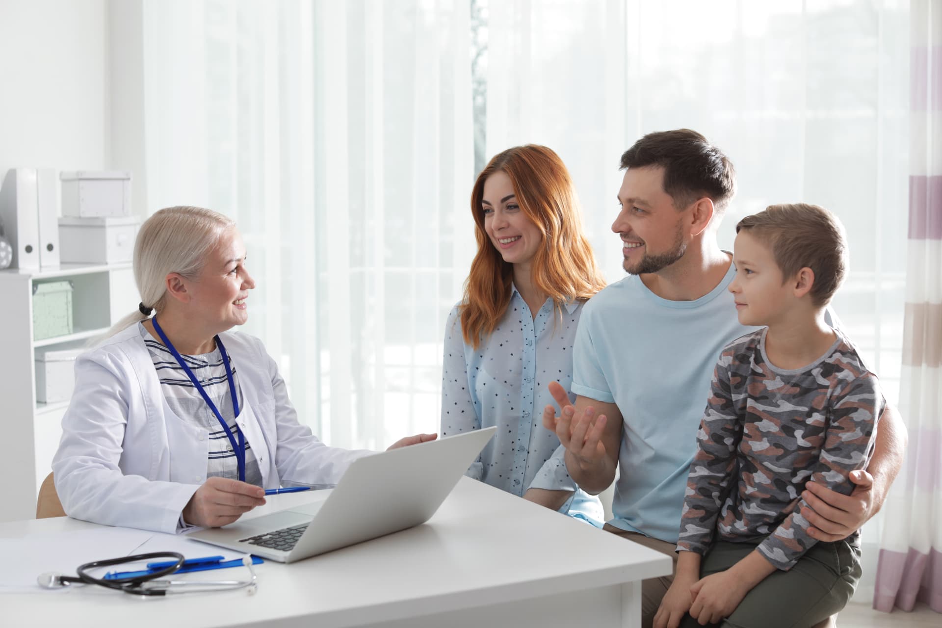 Family with child consulting with their doctor at a friendly office visit